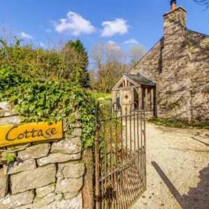 Iron gate opening up to the gravel path which leads to Birch Cottage