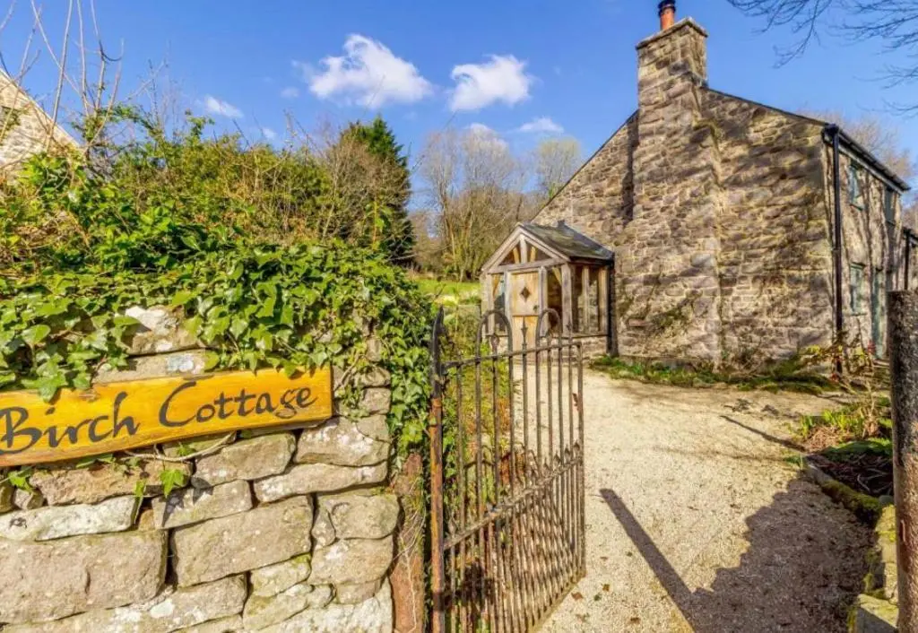 Iron gate opening up to the gravel path which leads to Birch Cottage
