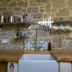 A picture of the kitchen sink with shelves of pots and pans