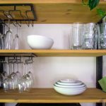 A picture of shelves with glasses and crockery on them